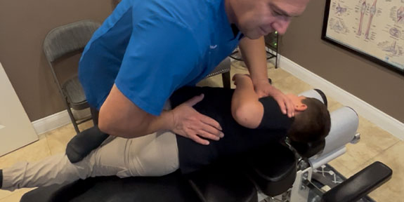 patient getting drop table chiropractic in La Verne for auto accident injury